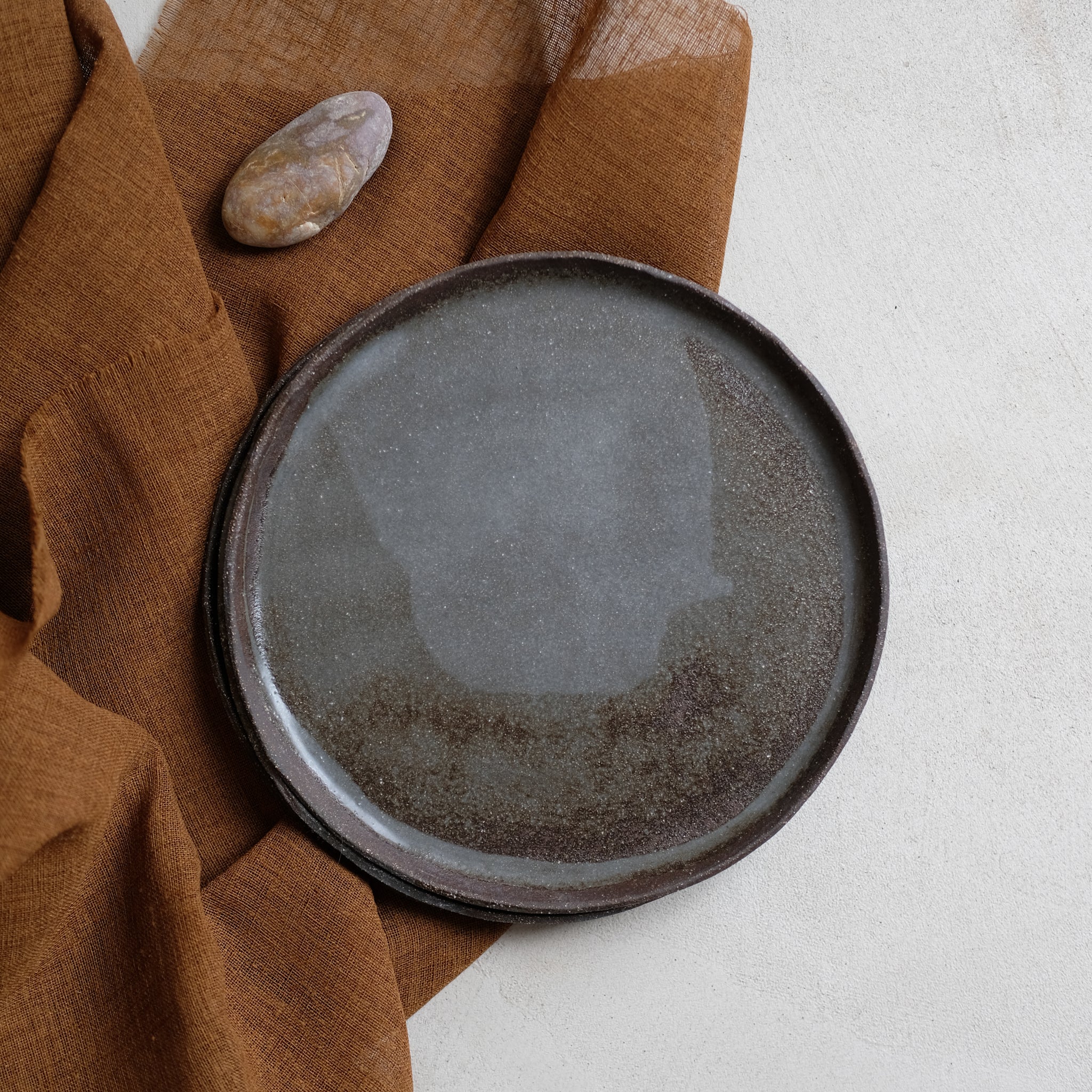 Assiette en grès noir chamotté de la céramiste Elsa Haas