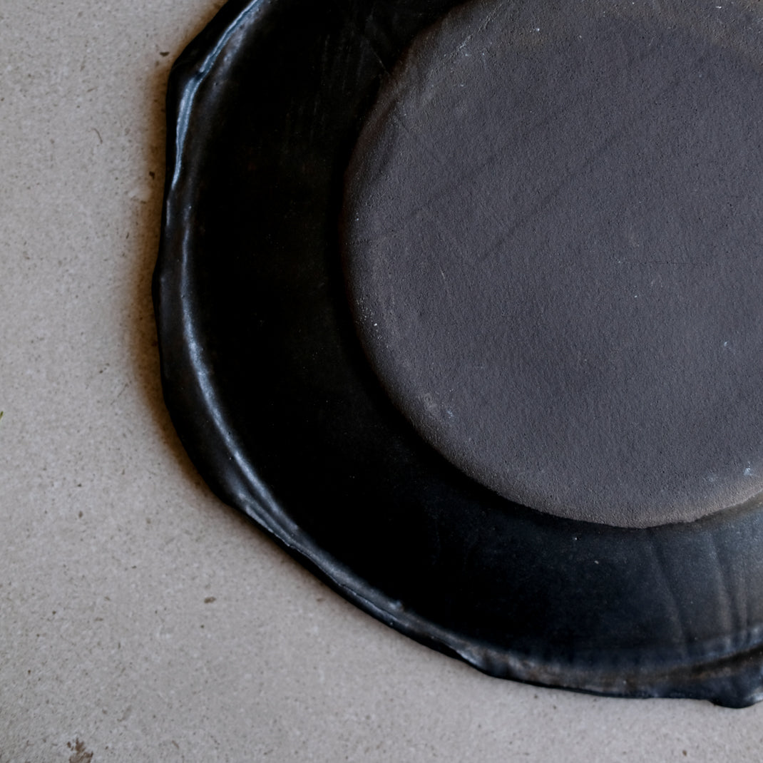 Assiette en grès noir réalisée à la main par Yellow Nose Studio chez Brutal Ceramics