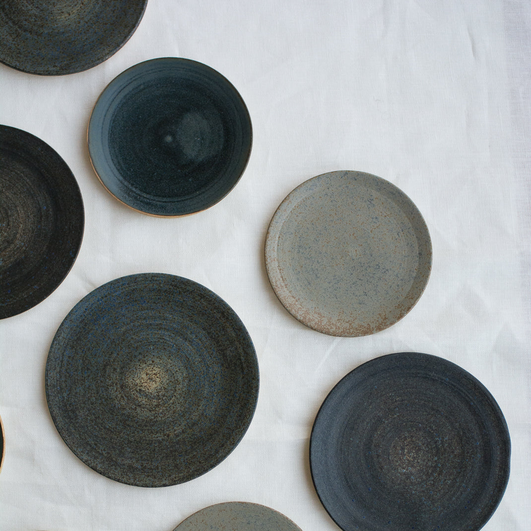 Petite assiette verte foncée realisée à la main par la céramiste Patricia Vieljeux, dans son atelier parisien