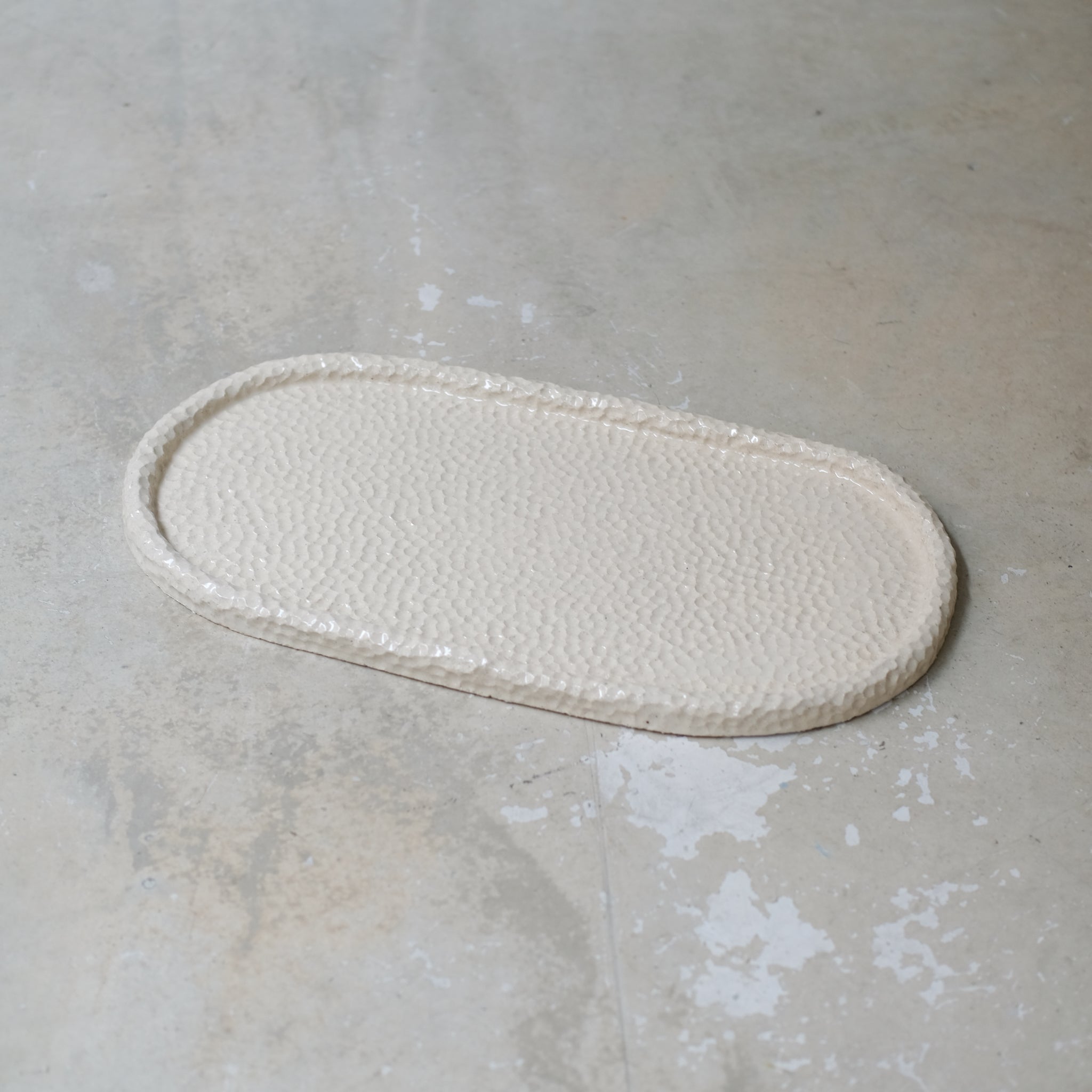 Plateau martelé en grès blanc par Simone Loo chez Brutal Ceramics