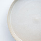 Assiette à rebord beige craquelé par la céramiste Laurence Labbé chez Brutal Ceramics