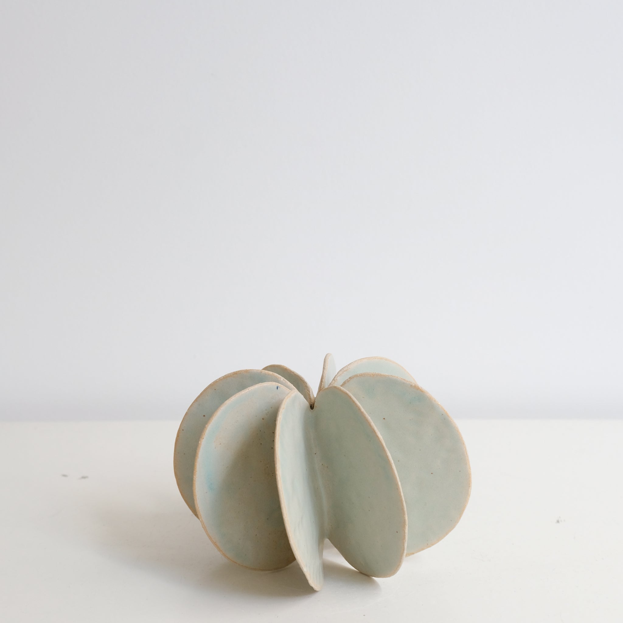 Objet Petale M en grès blanc D 13,3cm - vert céladon de Motoko Saigo chez Brutal Ceramics