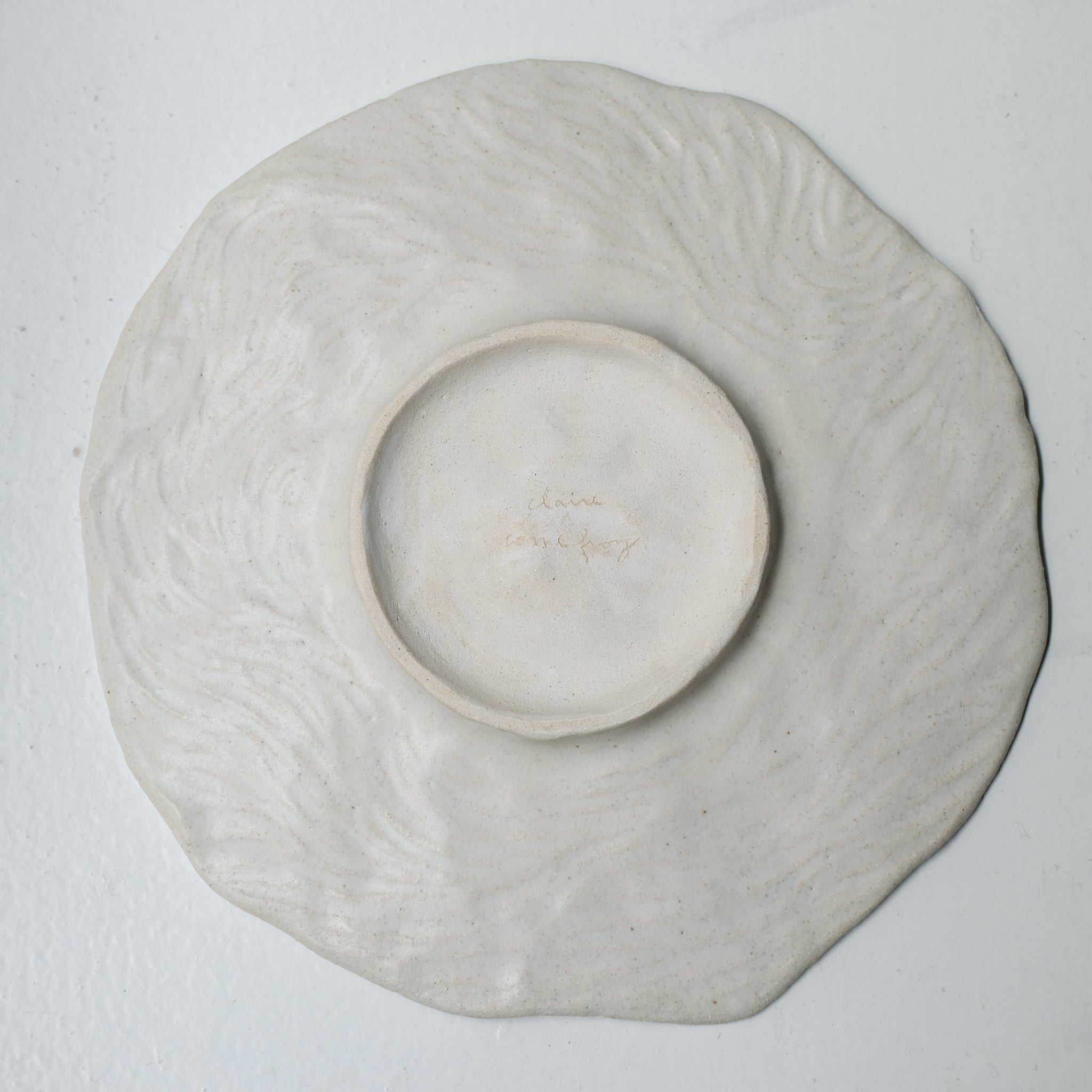Assiette sur pied en grès D23,5cm- Blanc texturé gravé de Claire Cosnefroy chez Brutal Ceramics