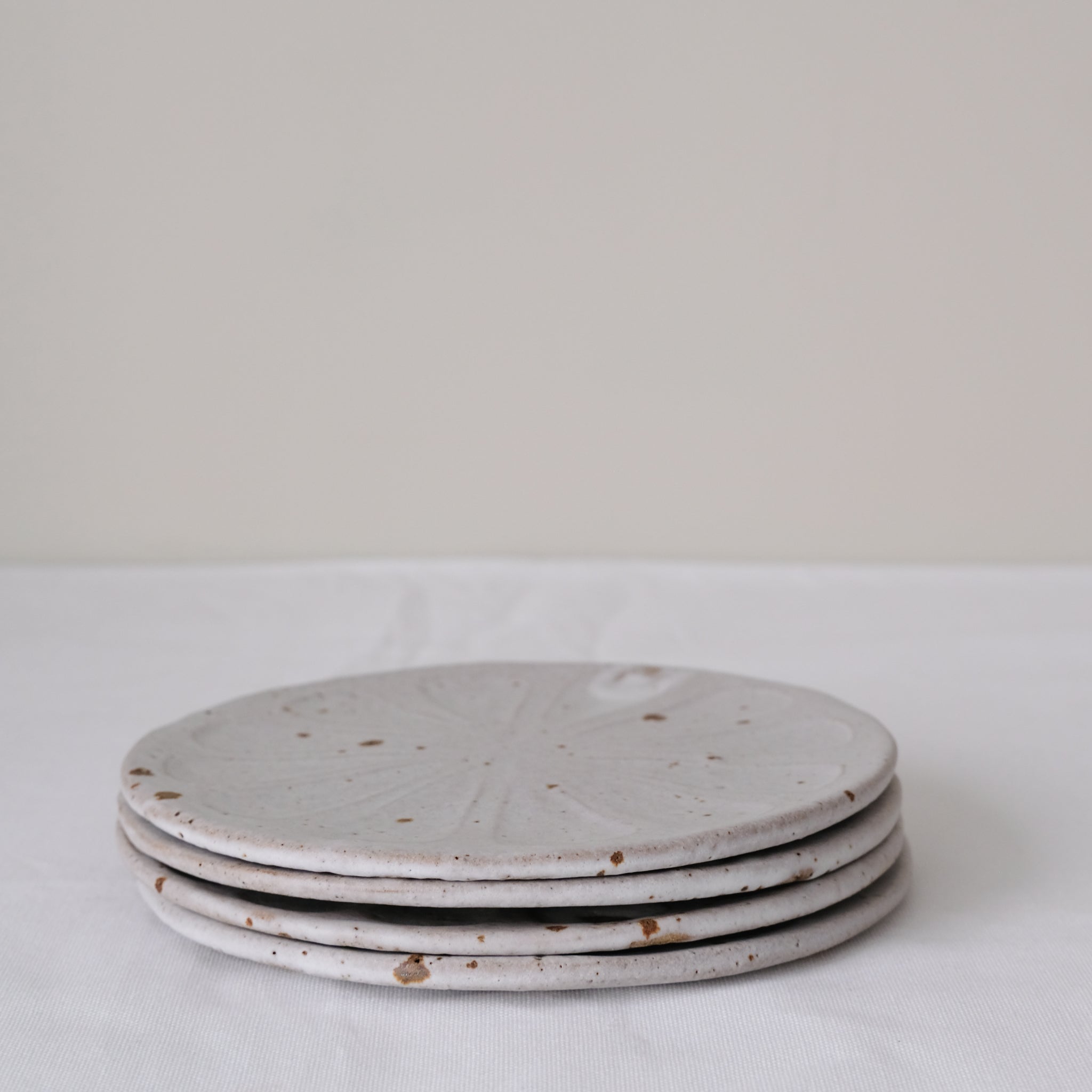 Assiette "Fleurs" en grès D 18cm - blanc tacheté d'Hélène Maury chez Brutal Ceramics