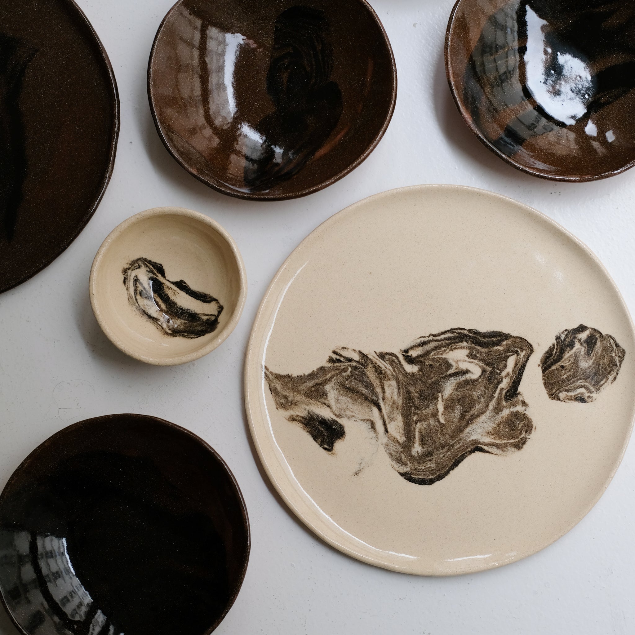 Plat rond D 32cm en terres mêlées - noir et beige de Léa Baldassari chez Brutal Ceramics