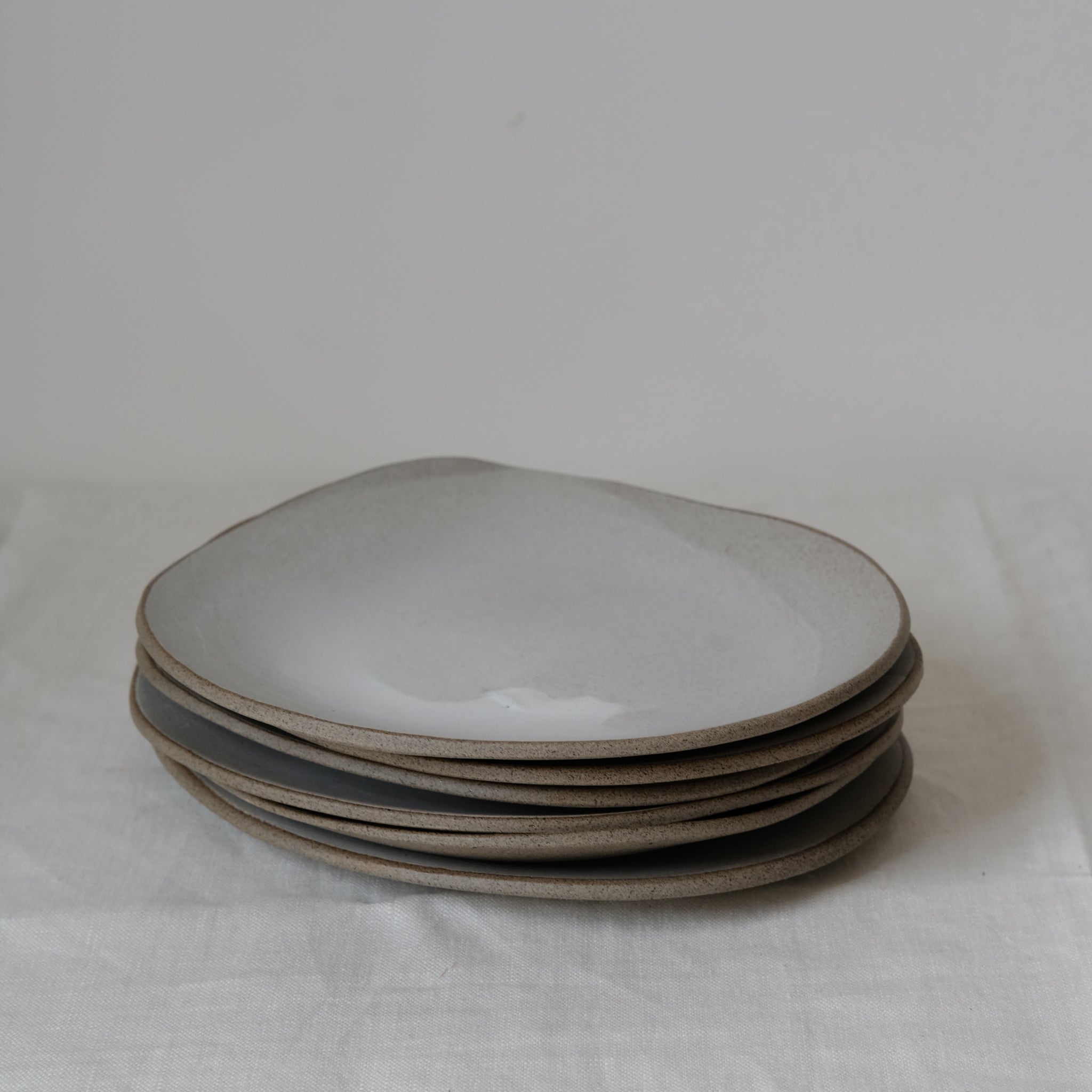 Assiette blanche en grès gris L 25cm par Hana Karim chez Brutal Ceramics