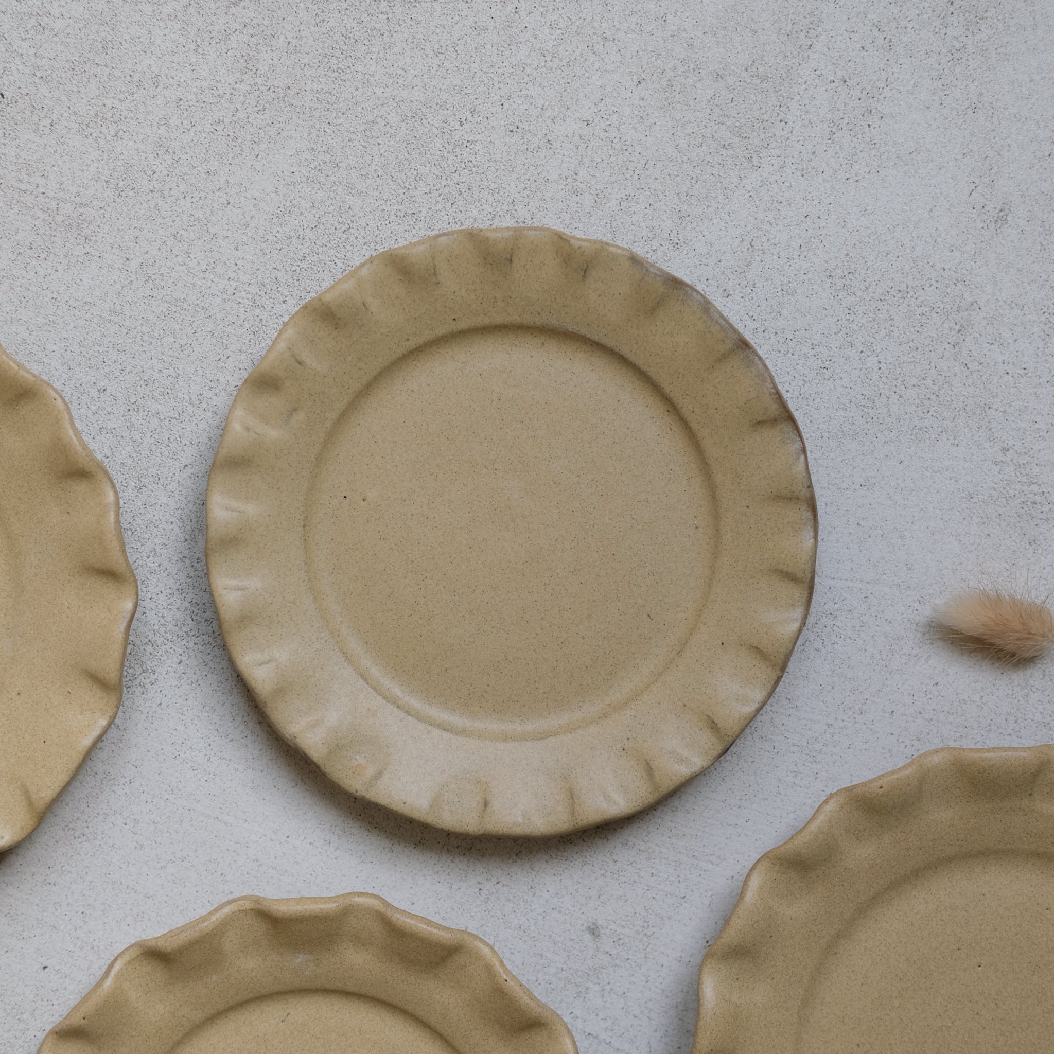 Les assiettes en argile rouge moutarde de Perla Valtierra chez Brutal Ceramics