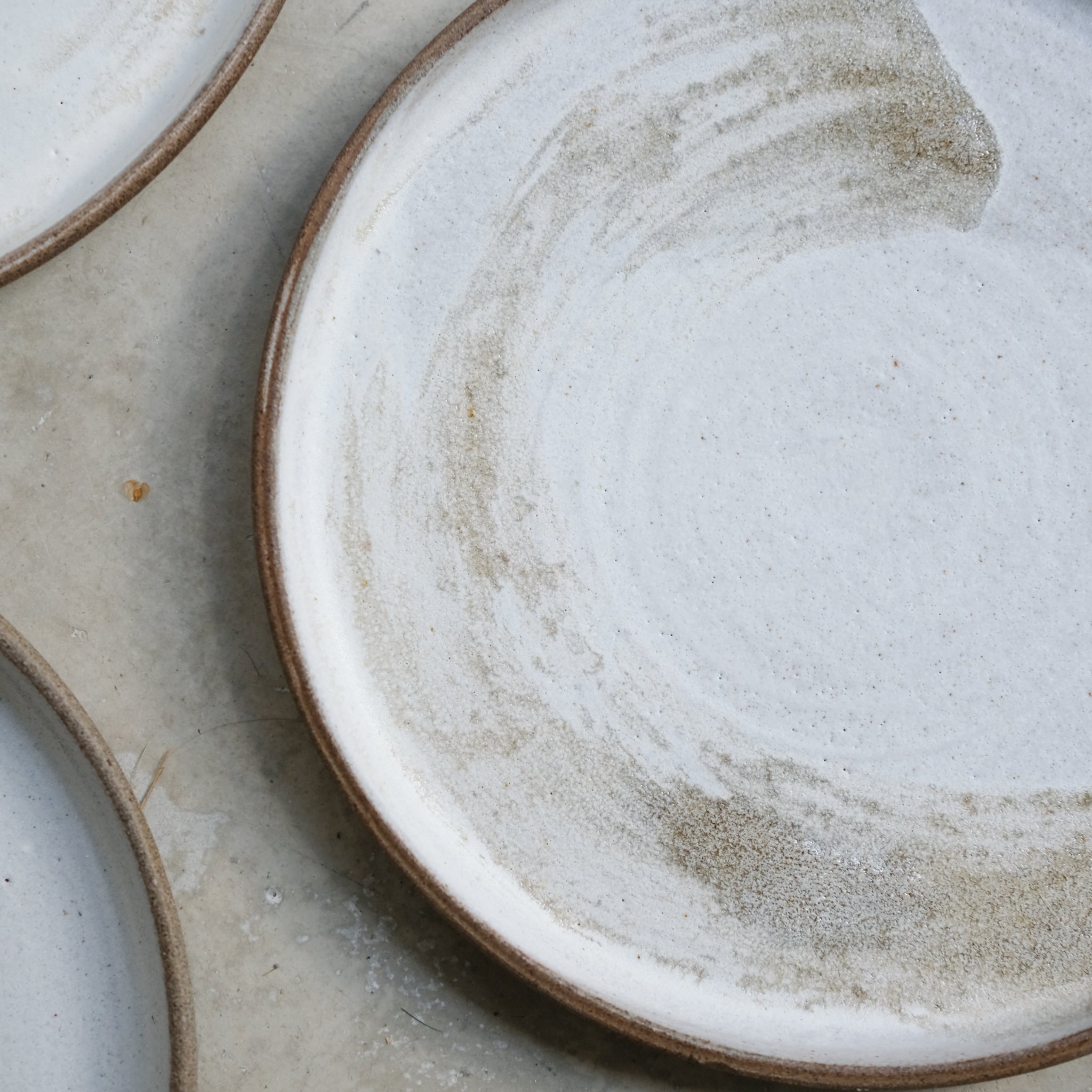 Assiette en grès gris D20,5cm blanc brume d'Eva Kengen chez Brutal Ceramics