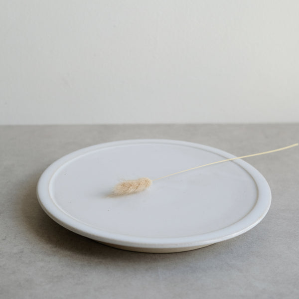 Assiette plate blanche sur pied de Moïo Studio chez Brutal Ceramics
