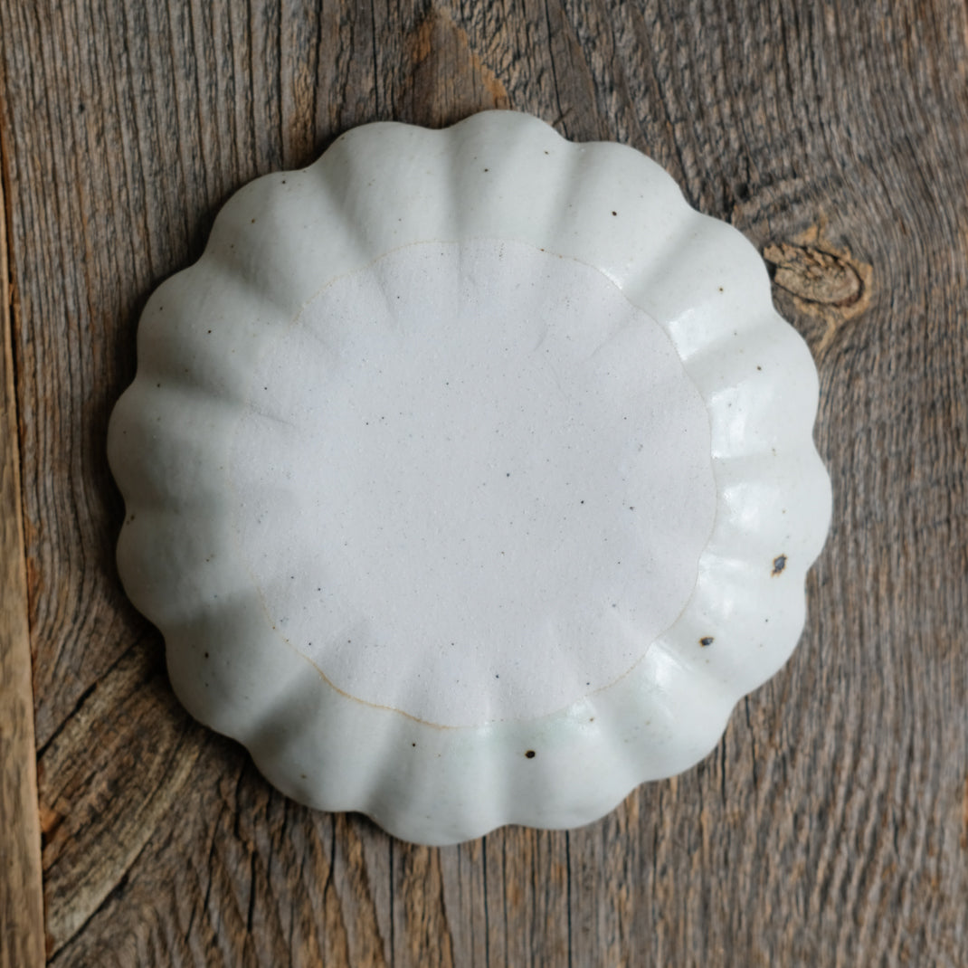 Assiette en grès blanche en forme de fleur réalisée par le céramiste Shin Ito