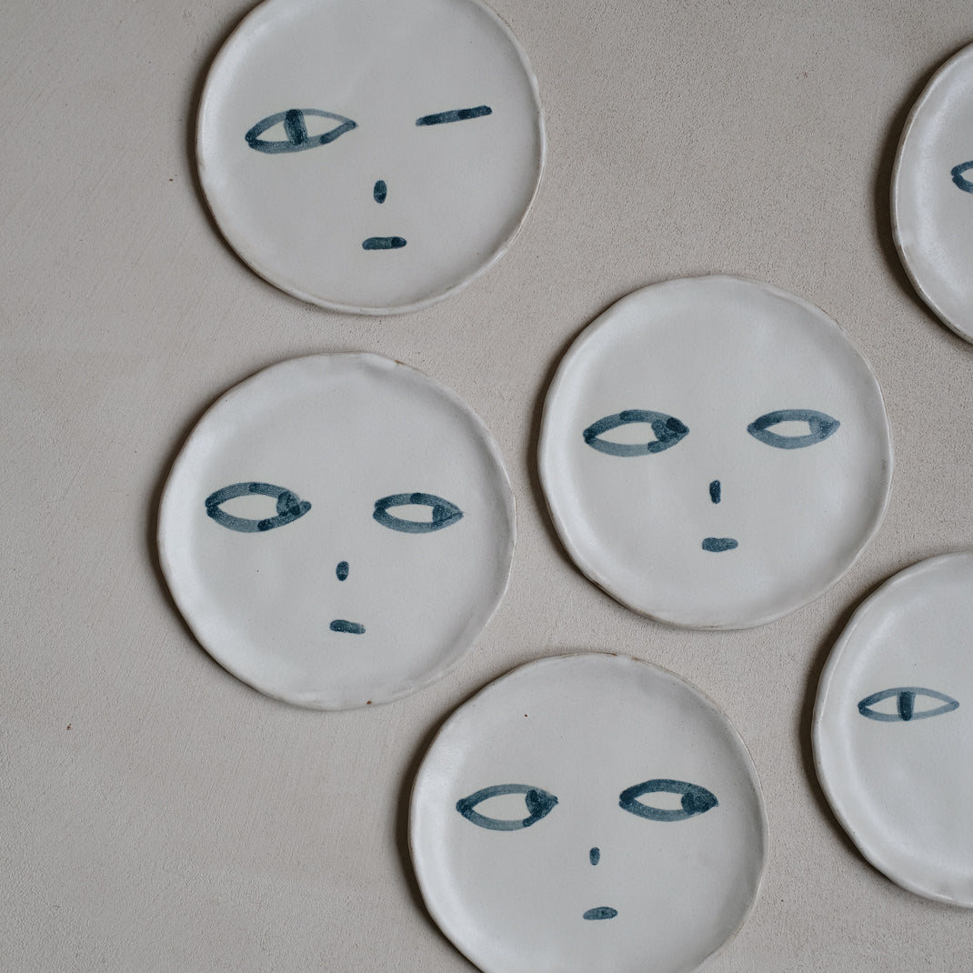 Plate in black stoneware face of Madoka Rindal at Brutal Ceramics