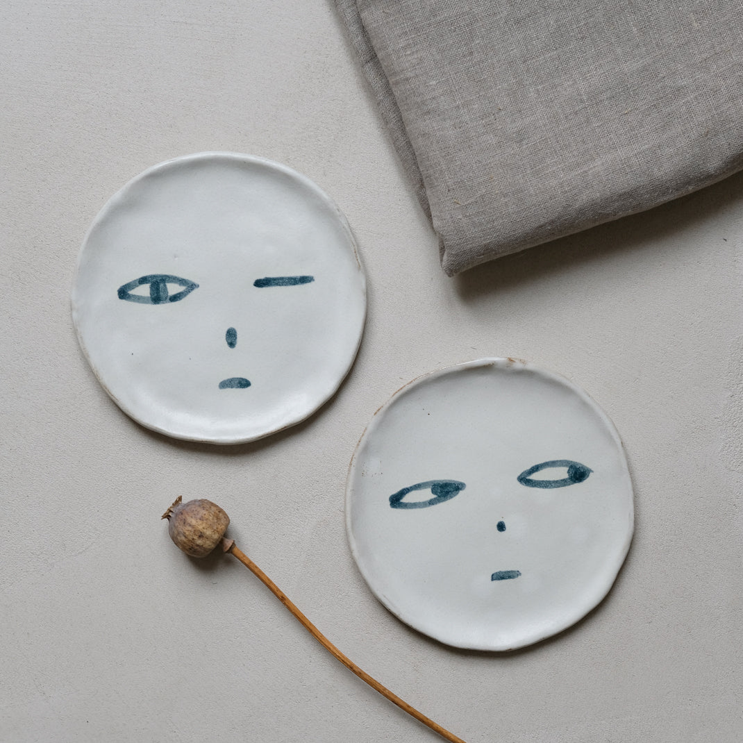 Plate in black stoneware face of Madoka Rindal at Brutal Ceramics